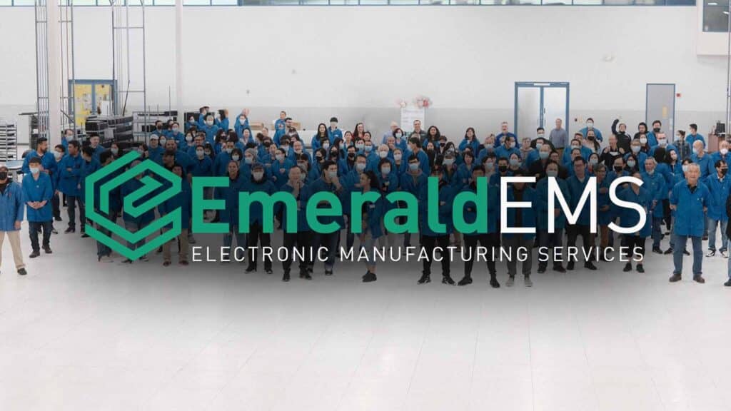 Employees behind the Emerald logo